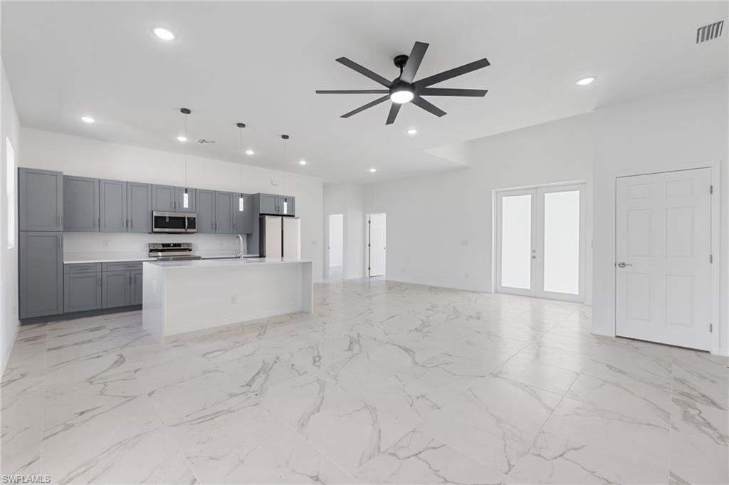 a view of a kitchen with a sink and microwave