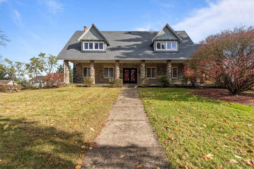 a front view of a house with a garden