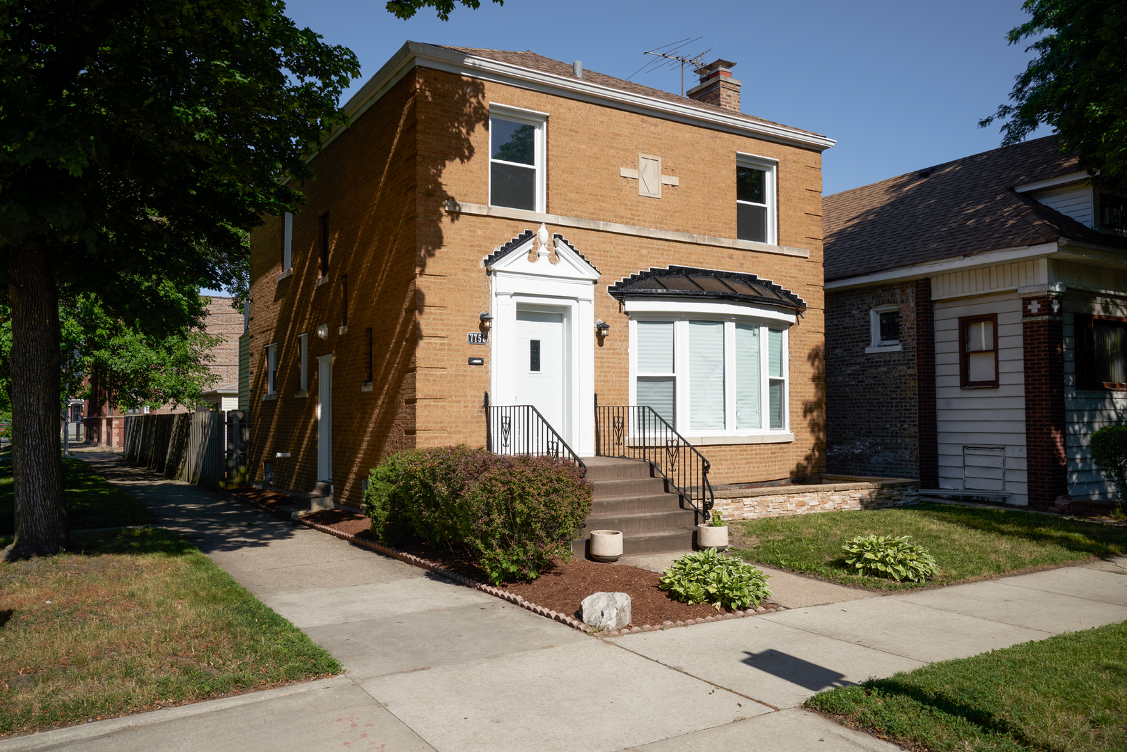 a front view of a house with garden