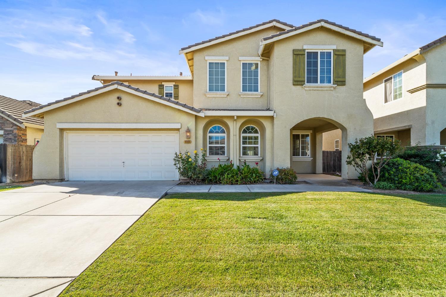 a front view of a house with yard