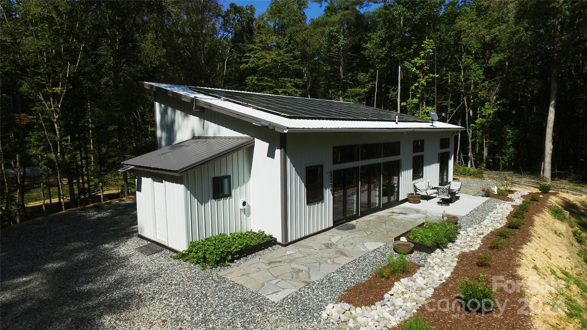 a view of a house with backyard and sitting area