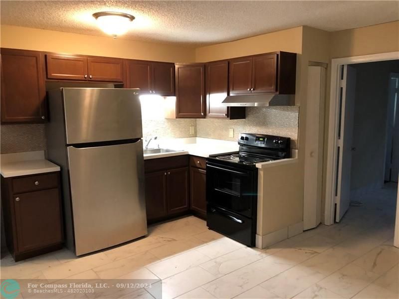 a kitchen with a refrigerator stove and microwave