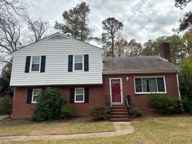 Split level home featuring a front lawn