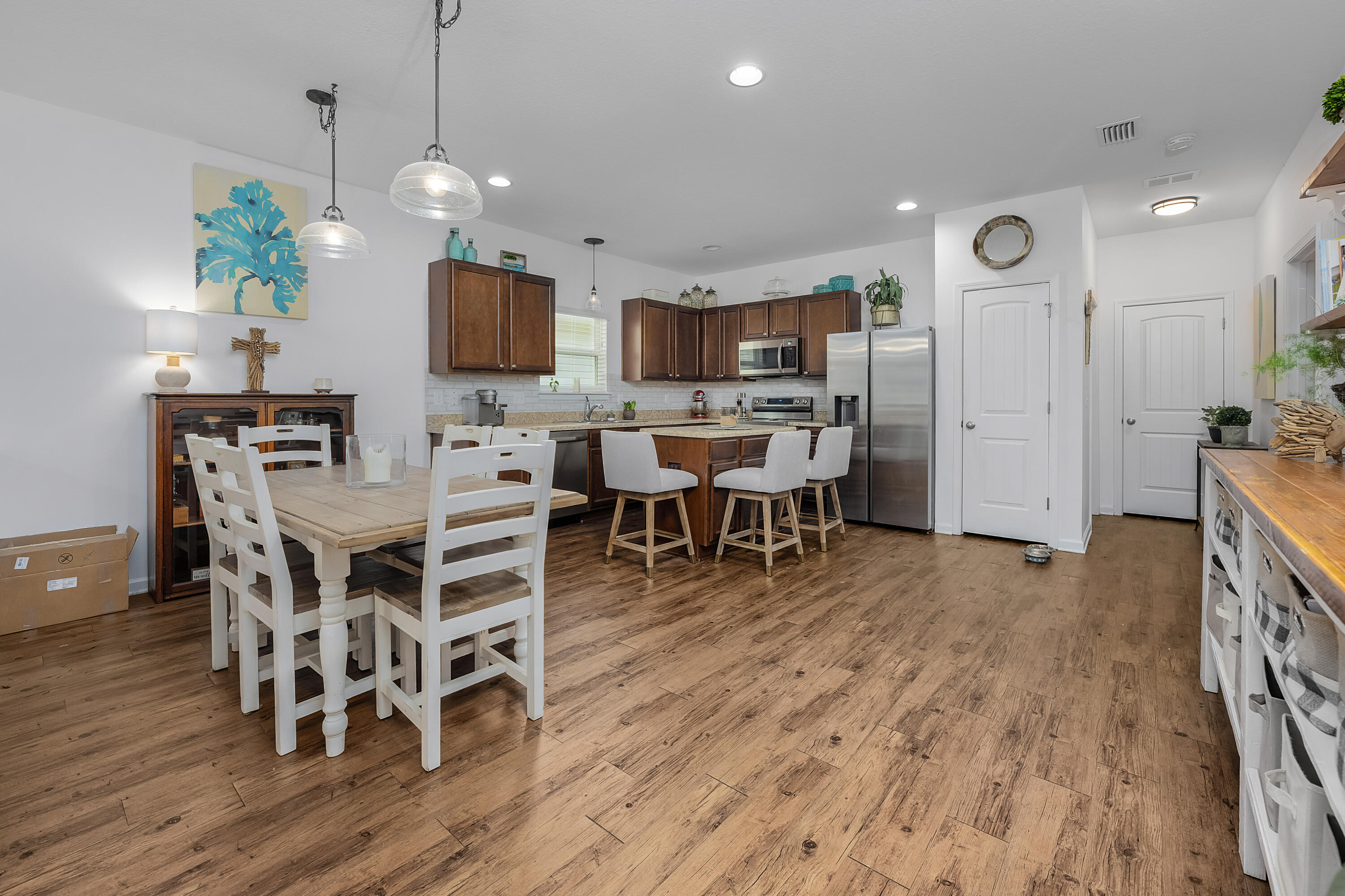 a view of a dining room with furniture wooden floor and chandelier