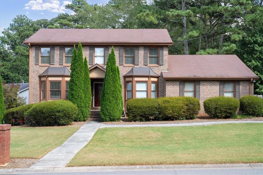 a front view of a house with garden