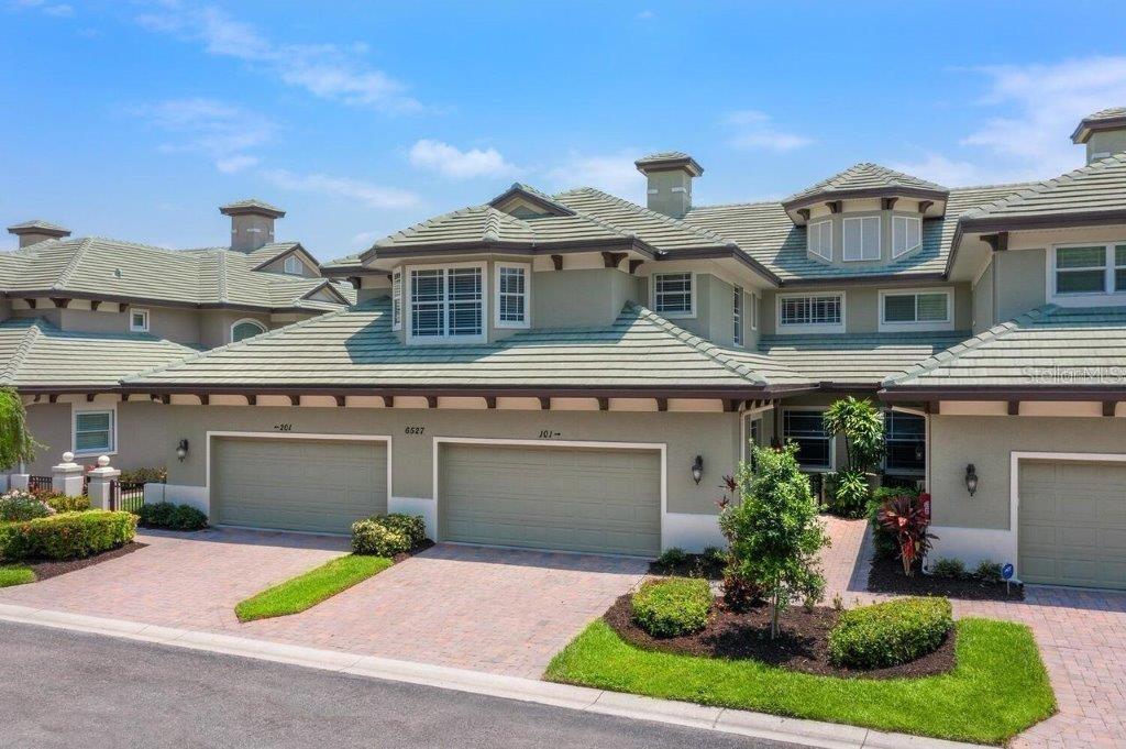 a front view of a house with a yard and garage