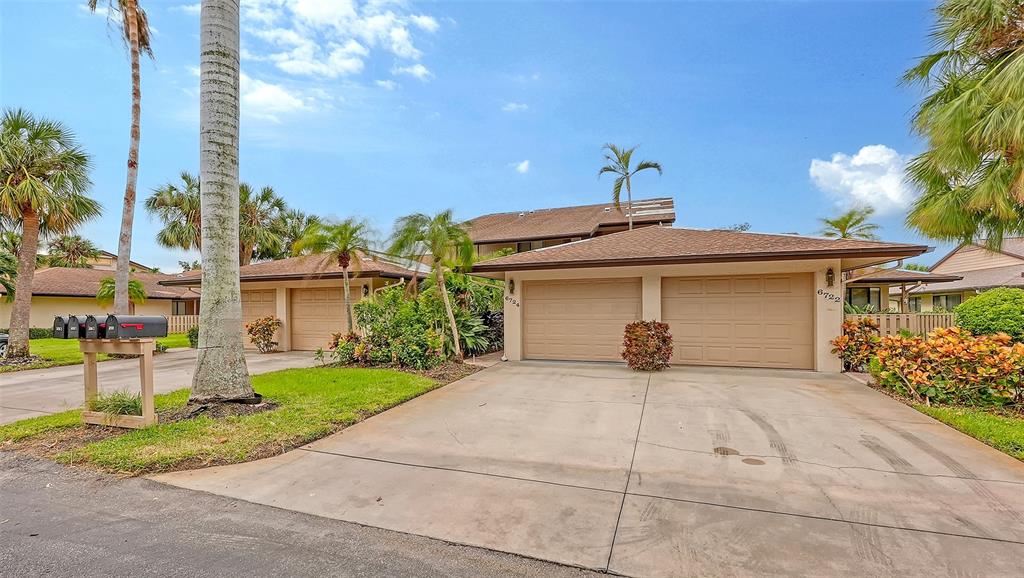 a view of a house with a yard and garage