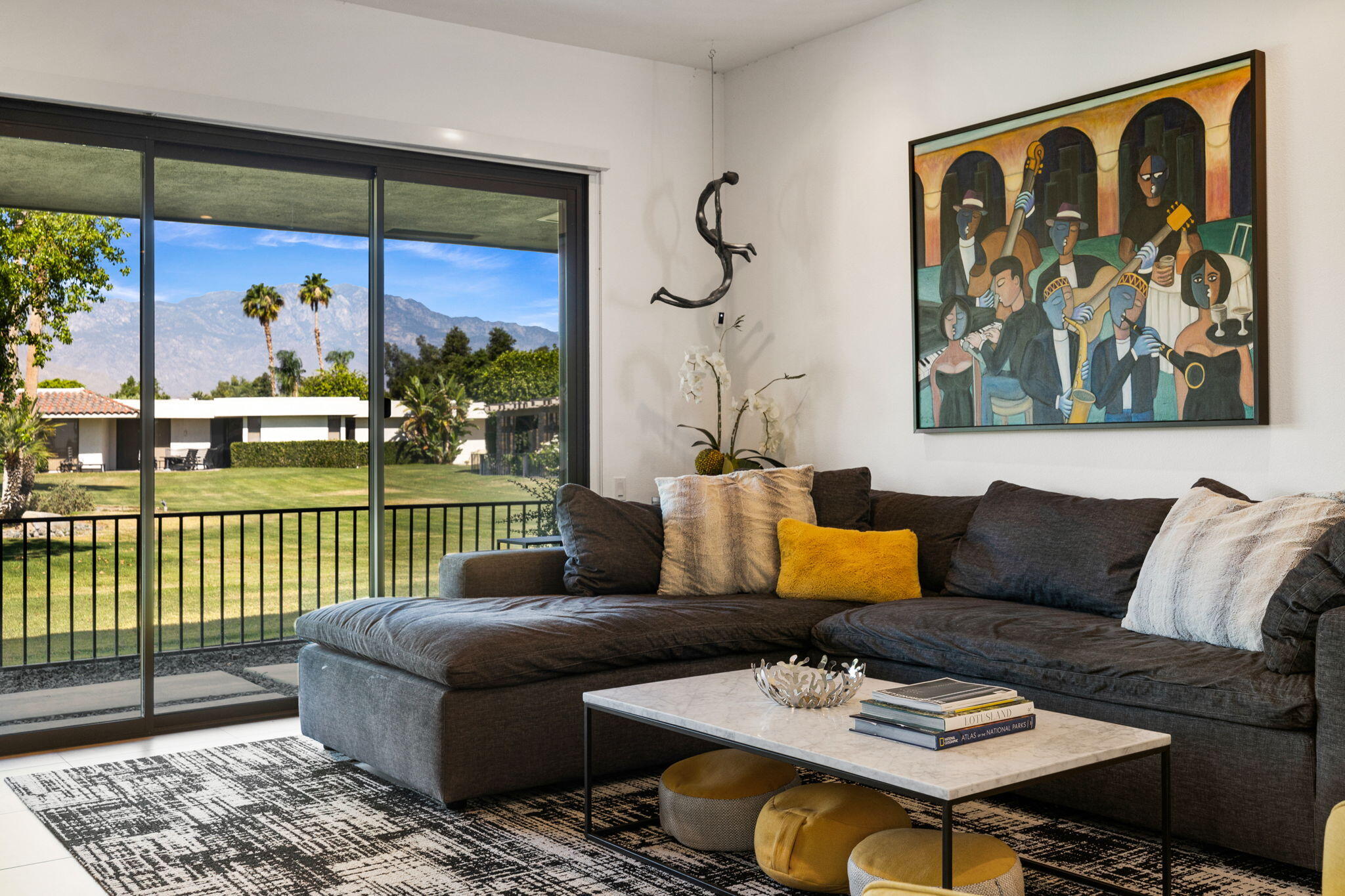 a living room with furniture and a painting on the wall