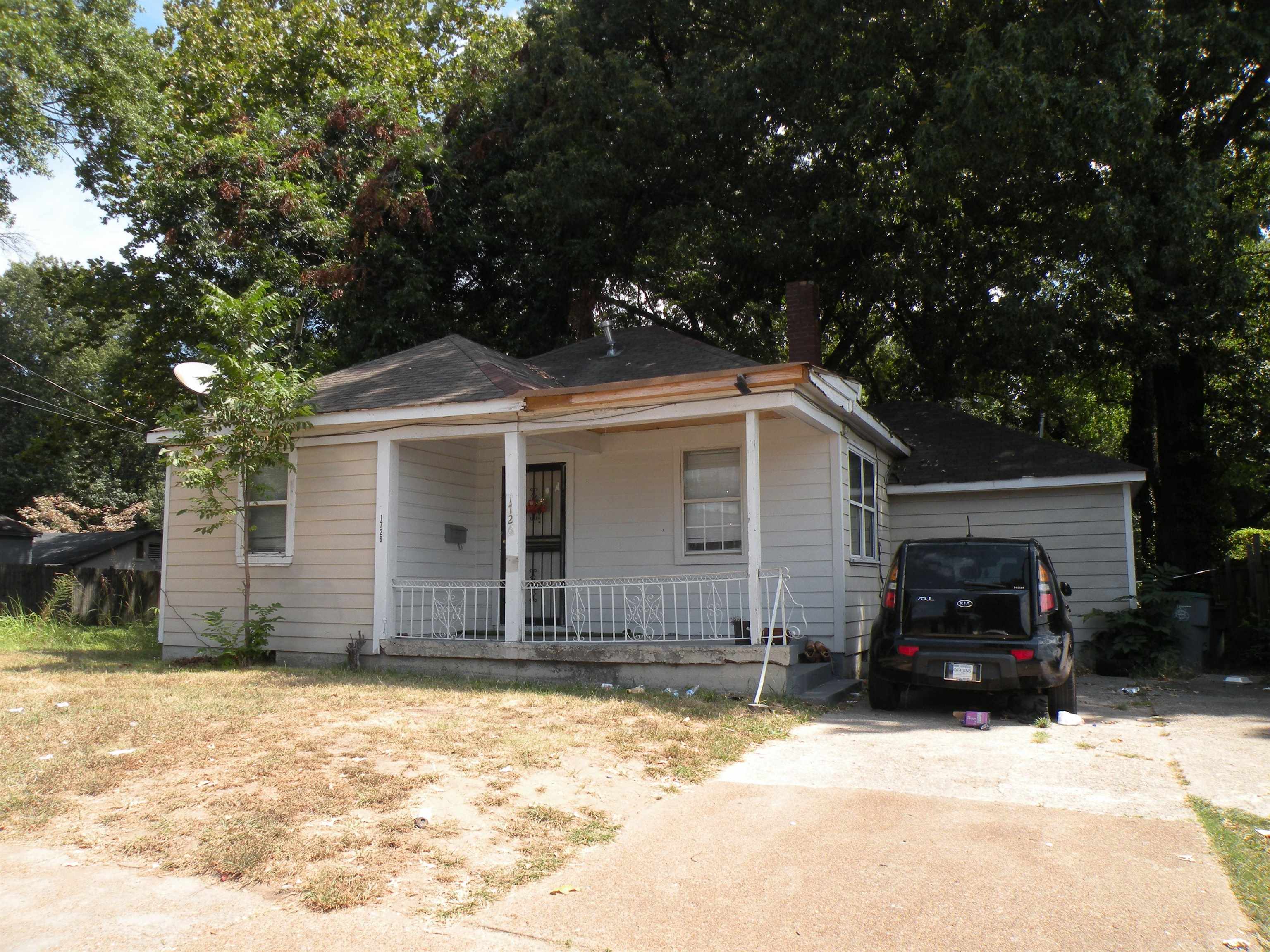 Bungalow-style house with a garage and a porch