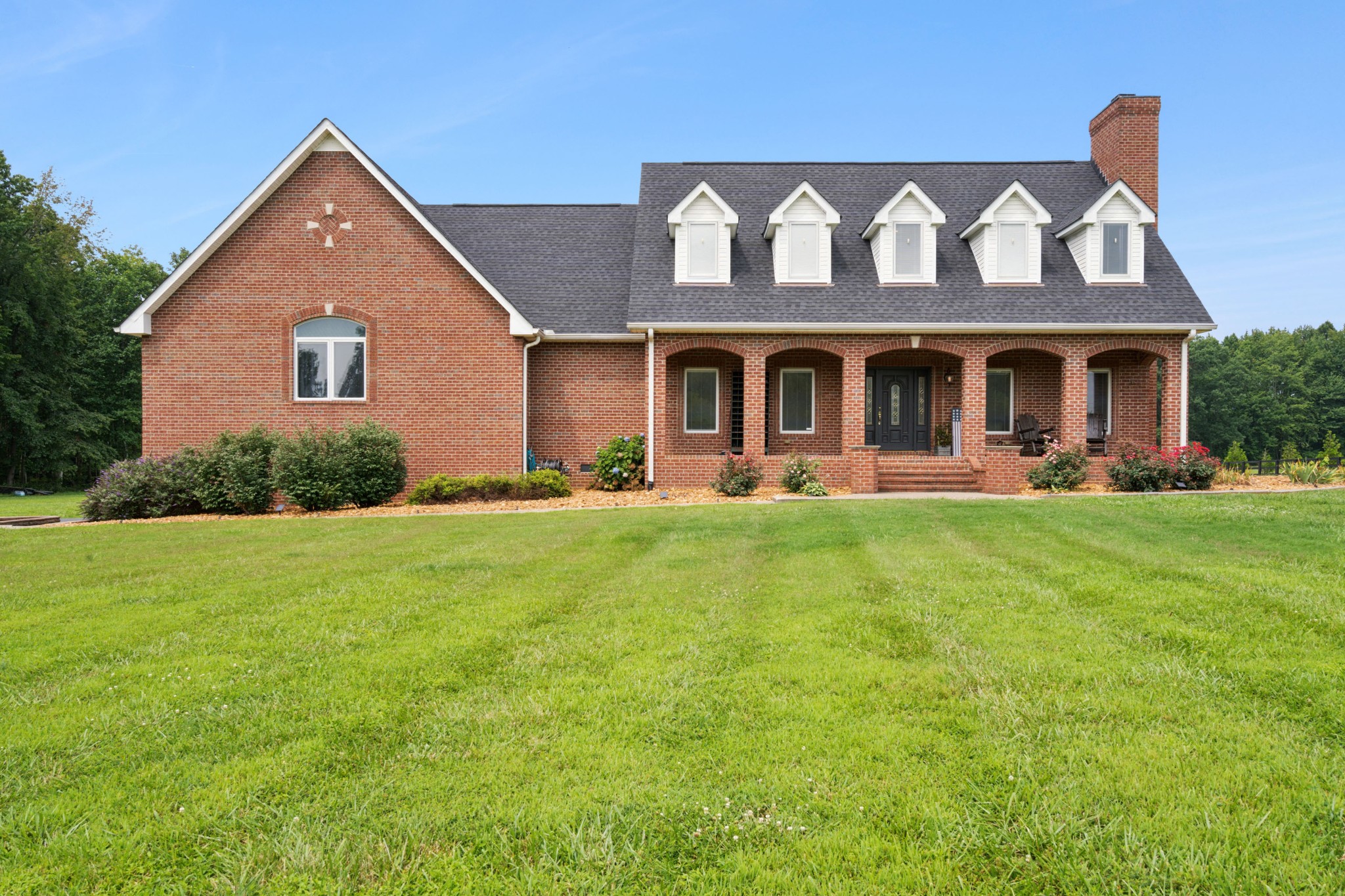 a front view of a house with garden