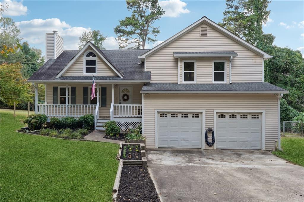 a front view of a house with a yard and garage