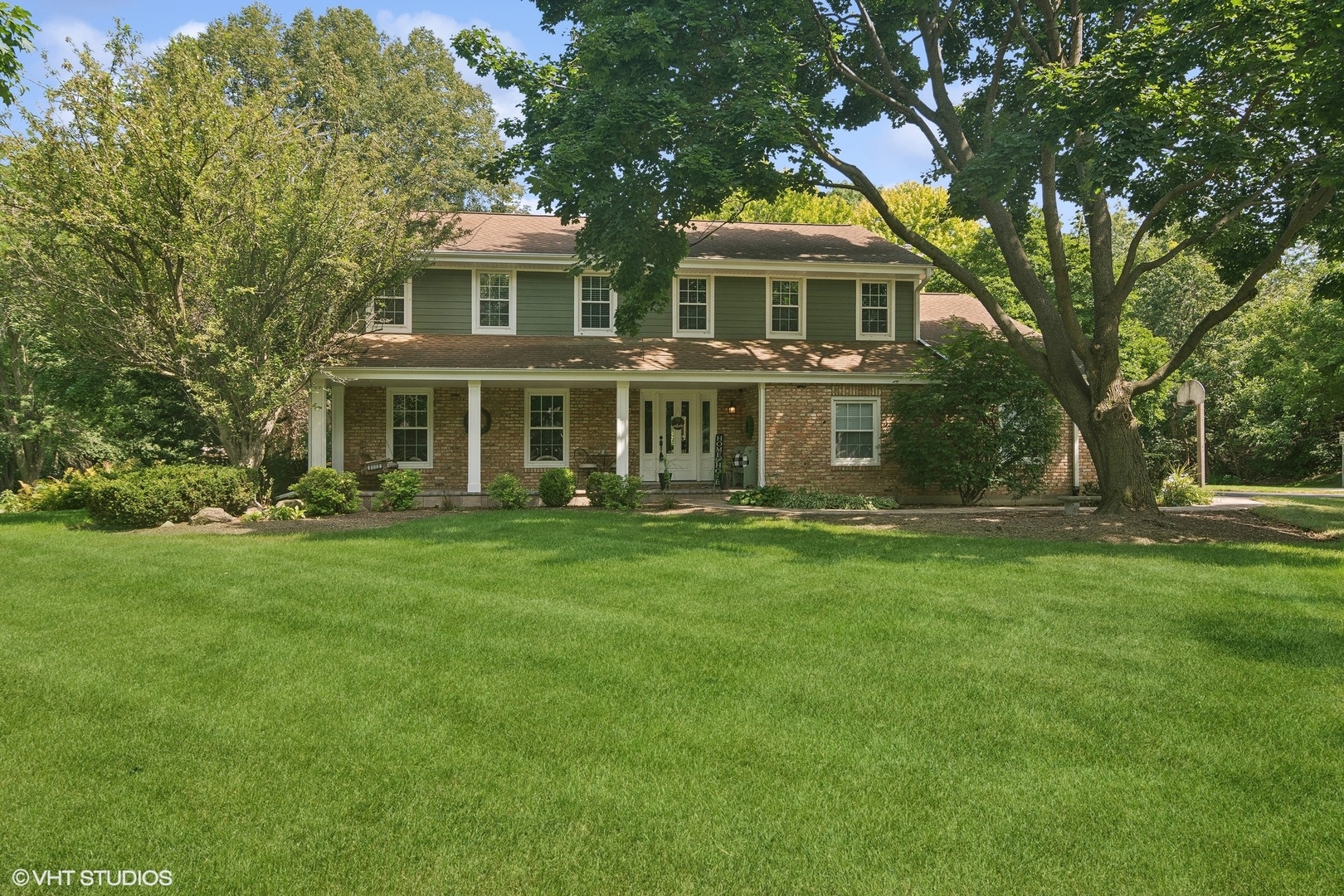 a front view of a house with a garden