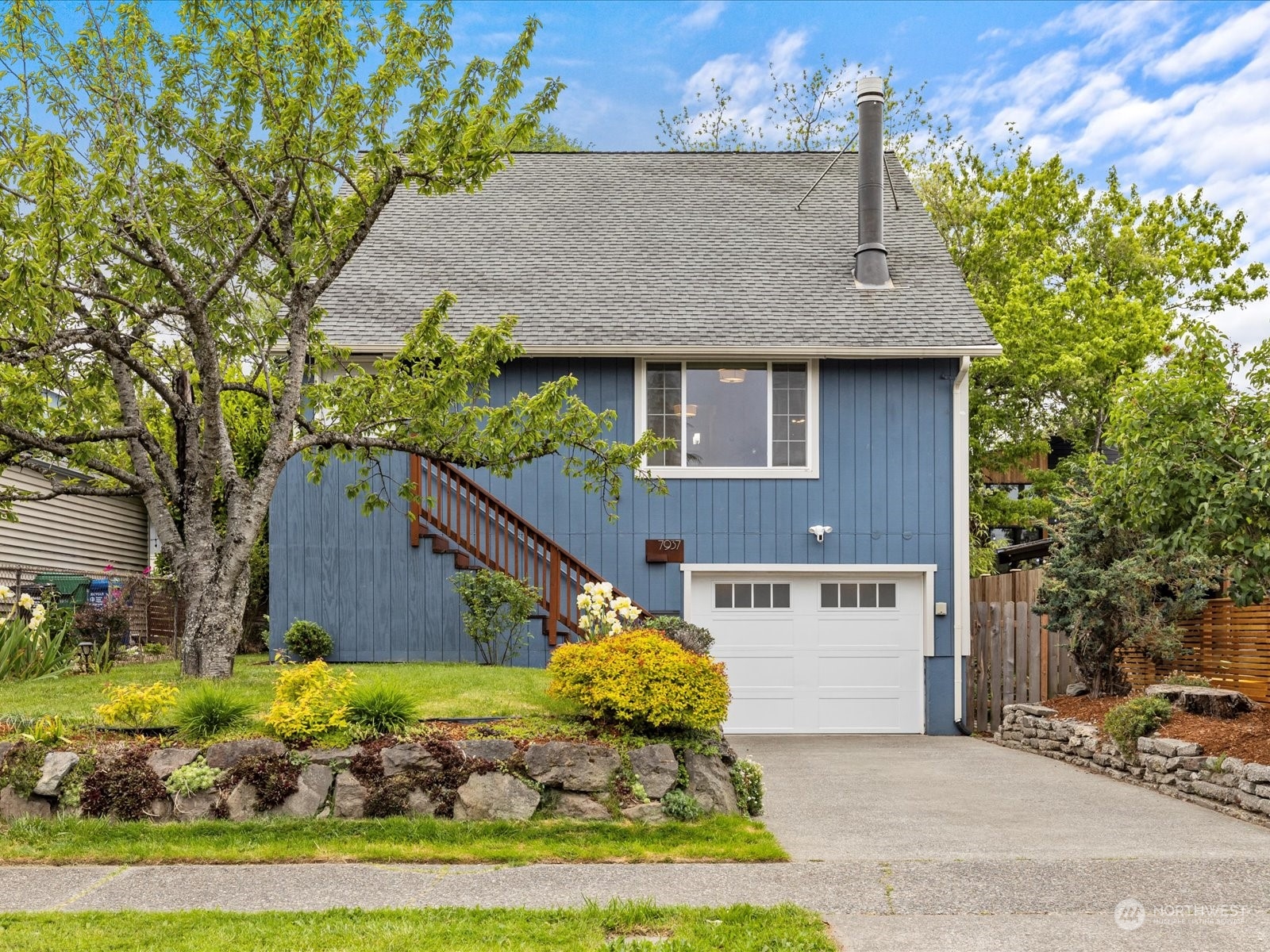 a aerial view of a house with a yard and potted plants