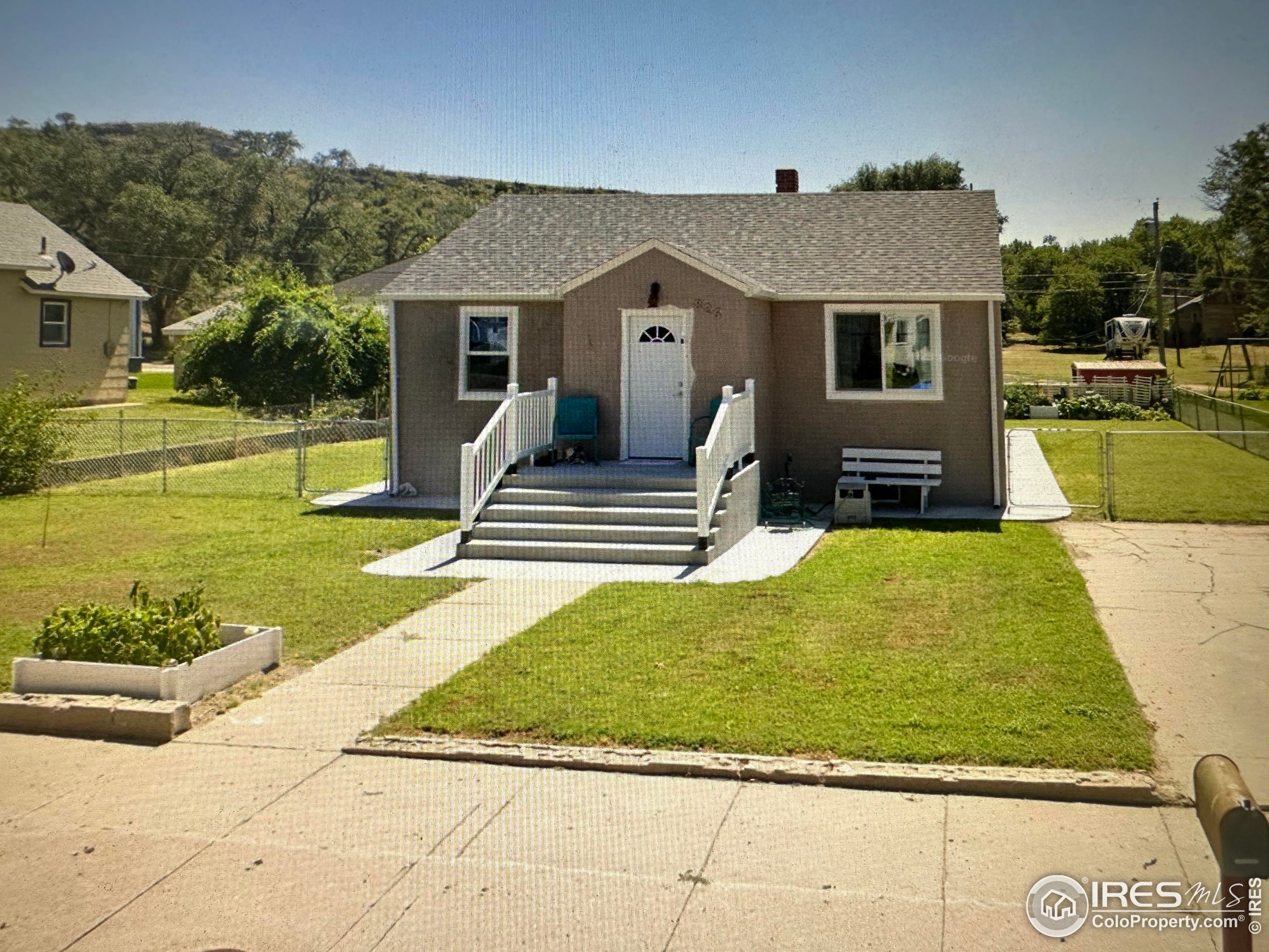 a view of a house with backyard and sitting area