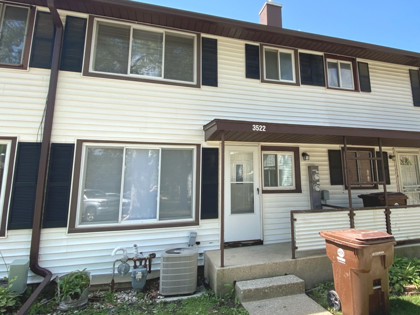 a front view of a house with sitting area