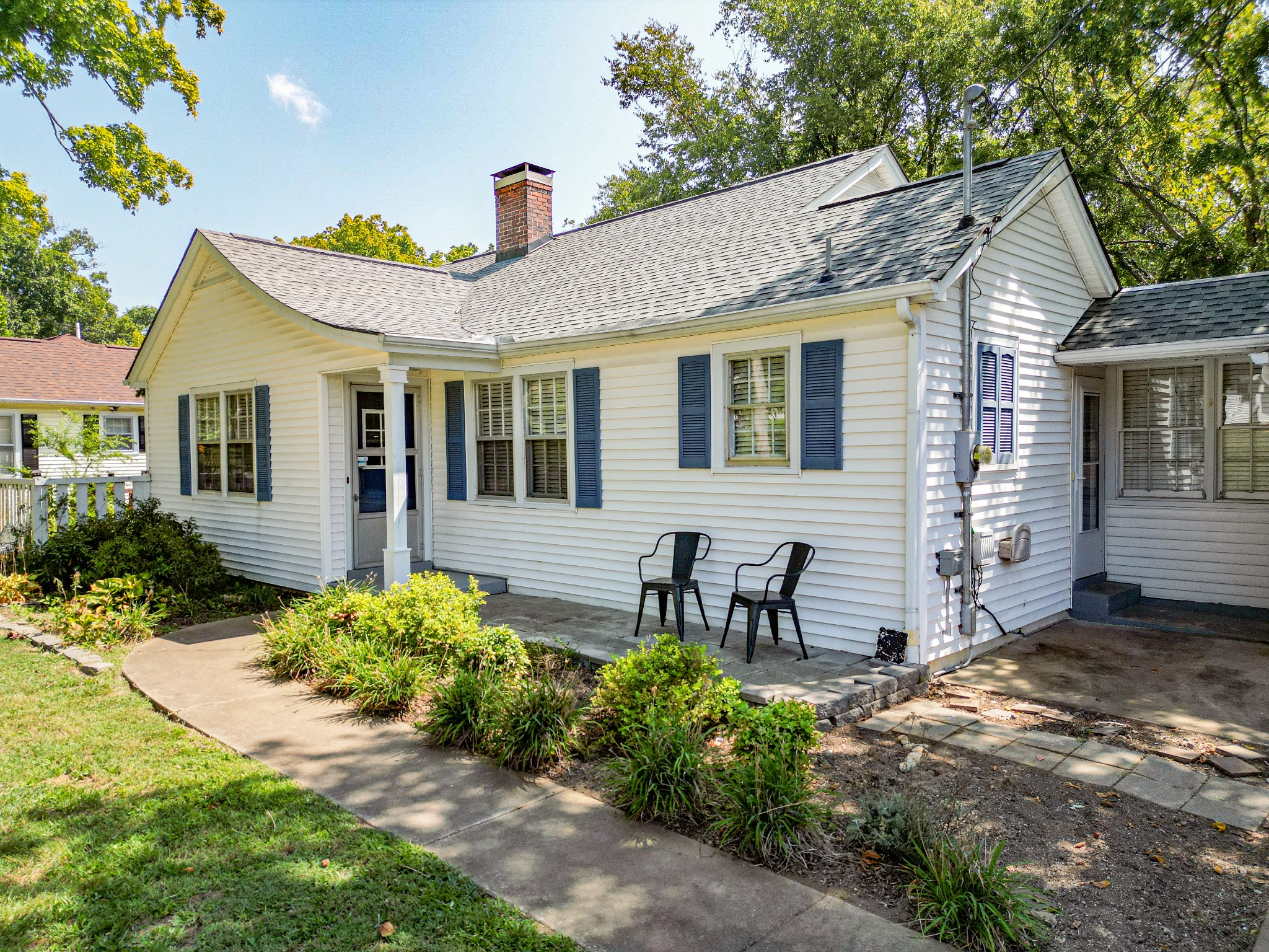 a front view of a house with a garden