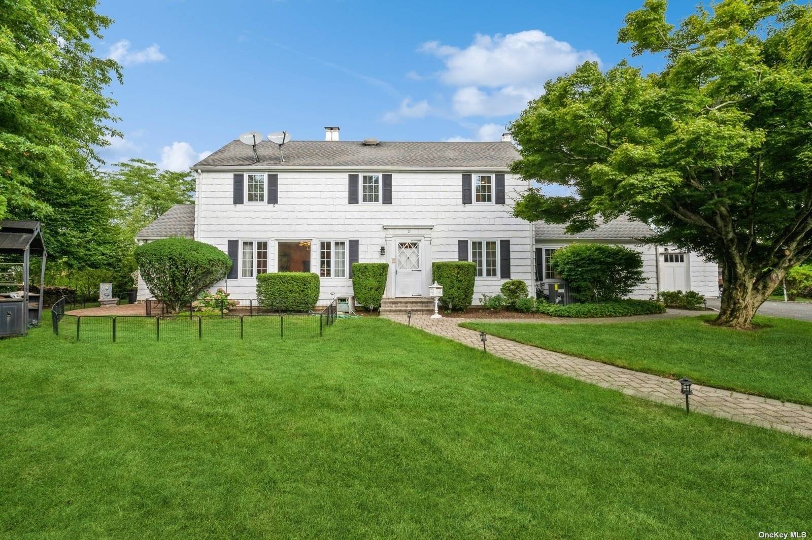 a view of house with a backyard and a patio