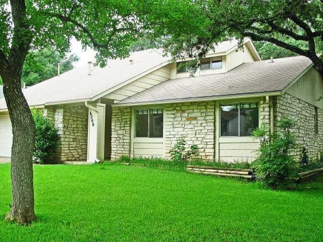 a view of a house with a yard and porch