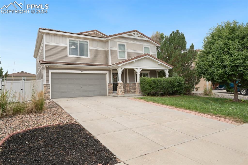 a front view of a house with a yard and garage