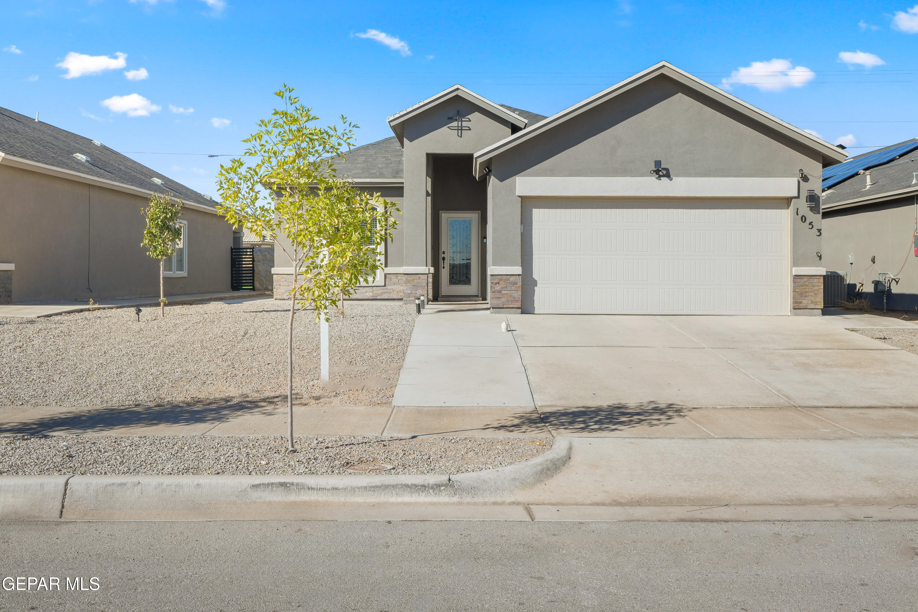 a front view of a house with a yard and garage