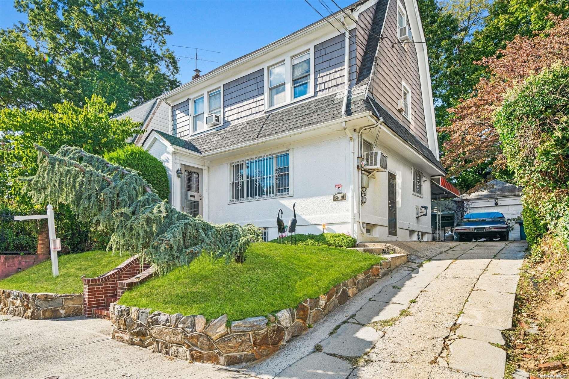 a front view of a house with garden