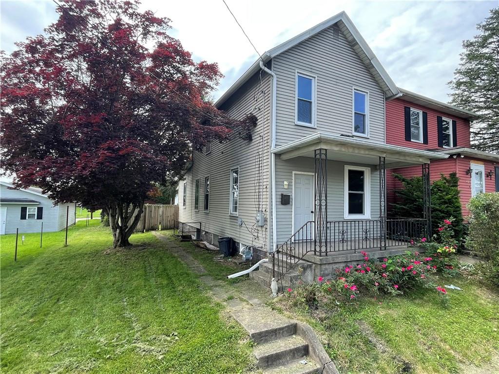 a view of house with a yard