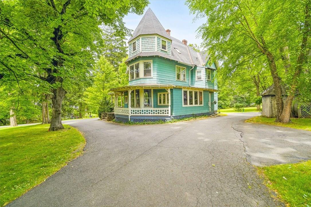 View of side of home with covered porch