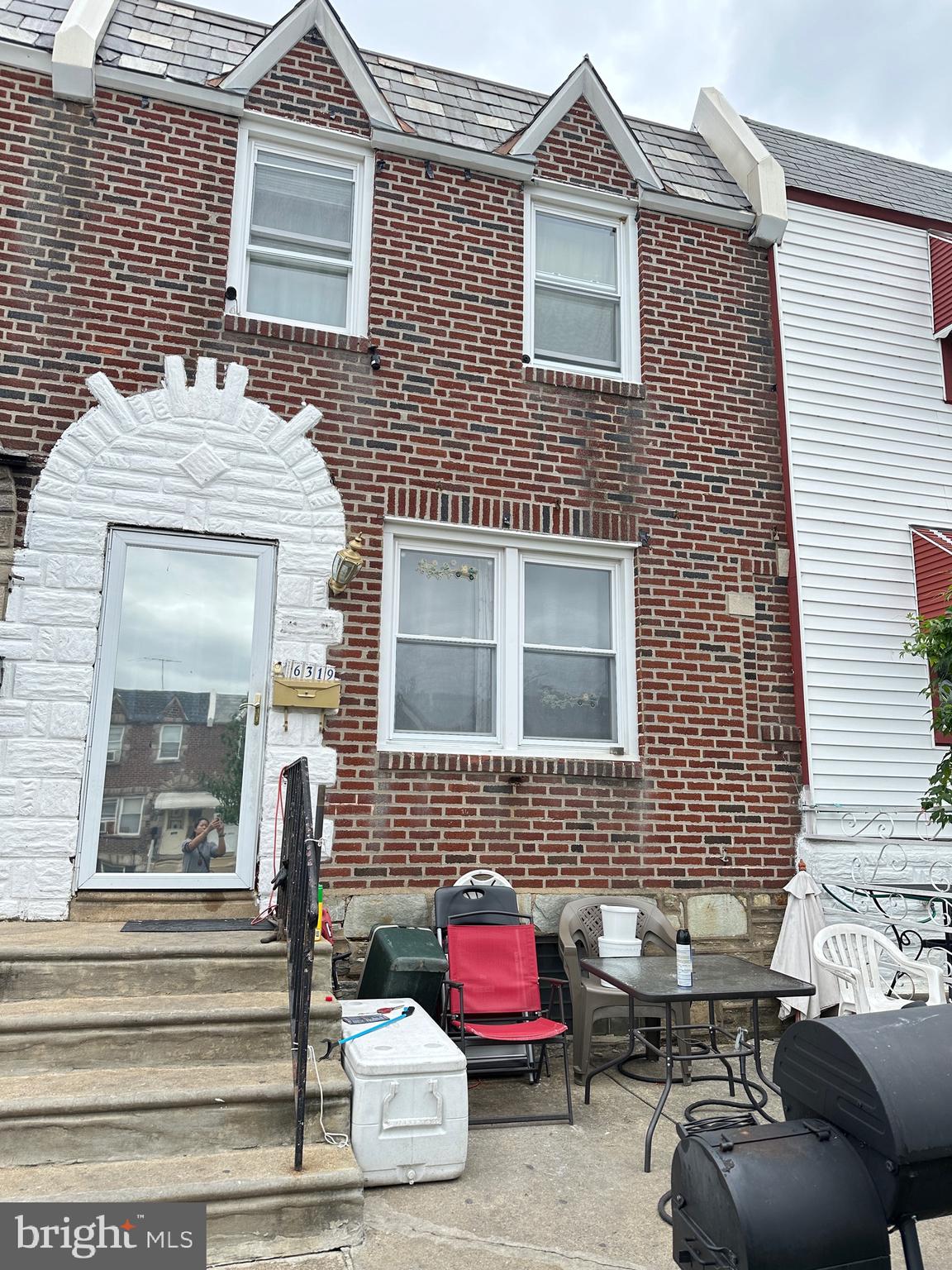 a front view of a house with outdoor seating