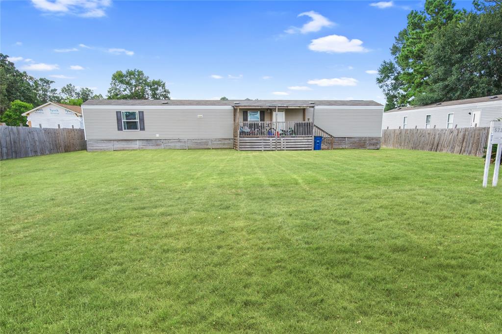 a view of a house with a backyard