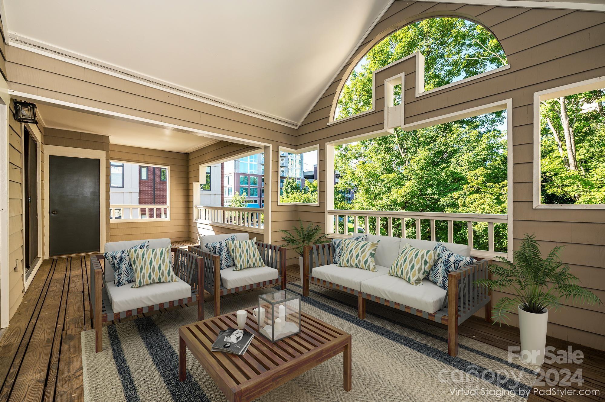 a balcony with furniture and a potted plant