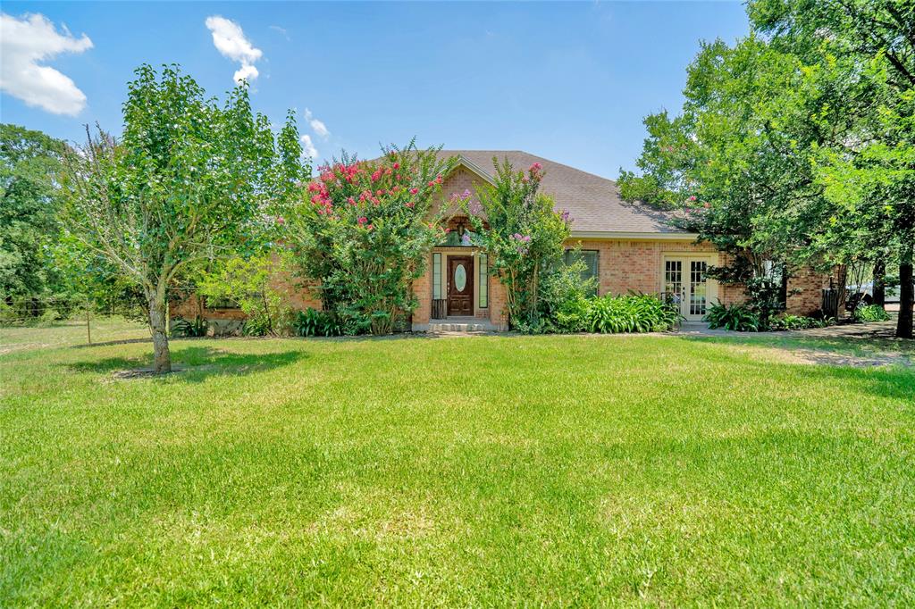 a front view of house with yard and green space