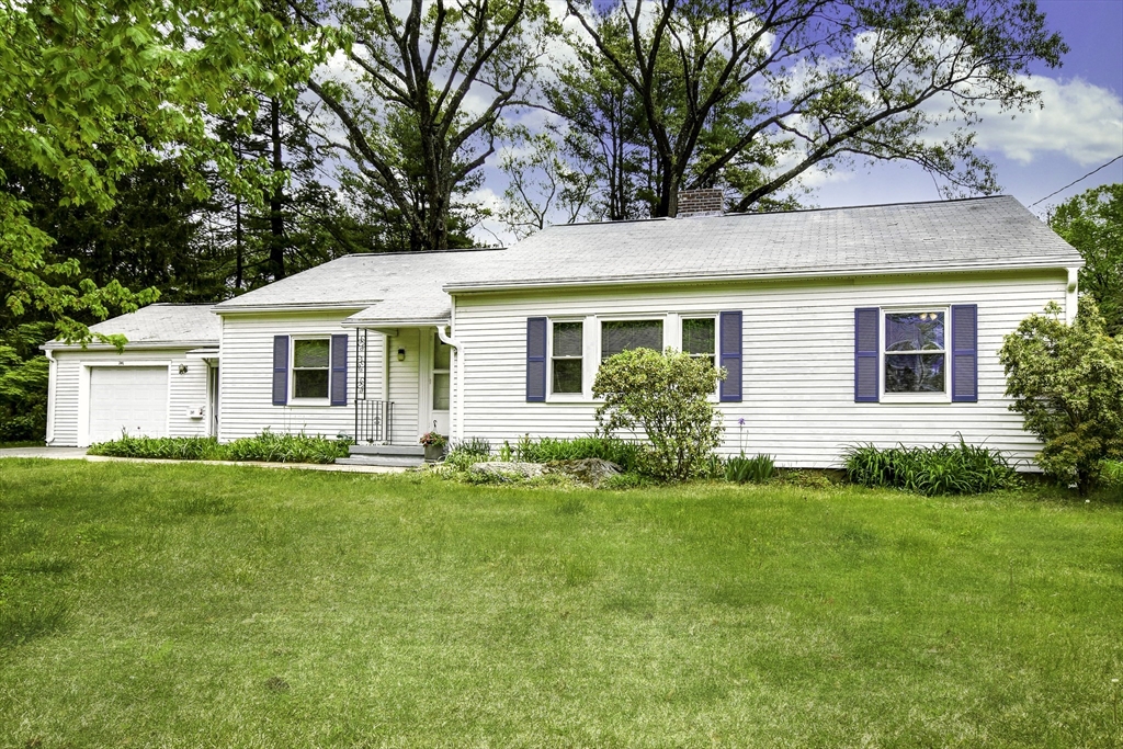 a view of a house with a backyard