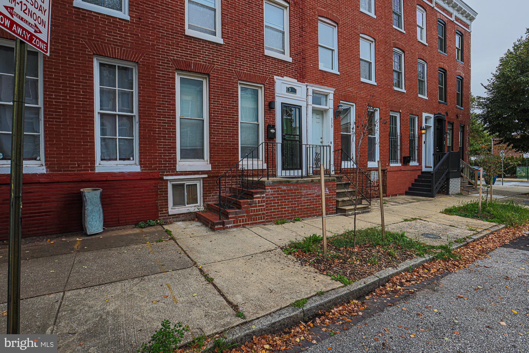 front view of a brick house with a yard