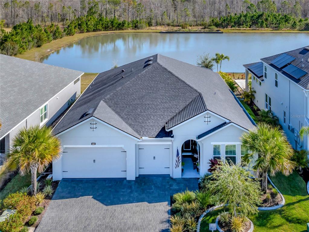 a view of a house with a yard and a pond