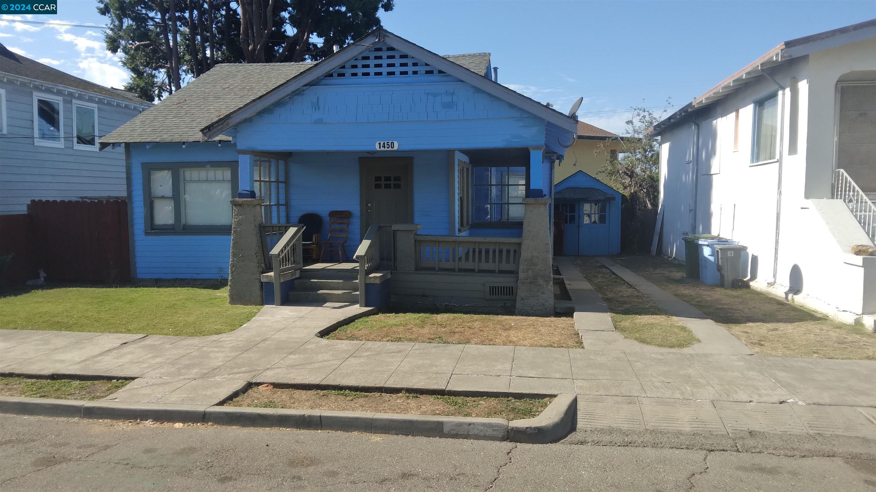 a view of a house with backyard porch and furniture