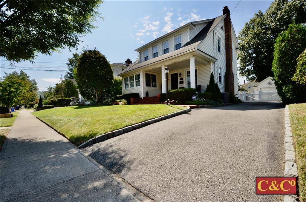 a view of a house with yard and tree s