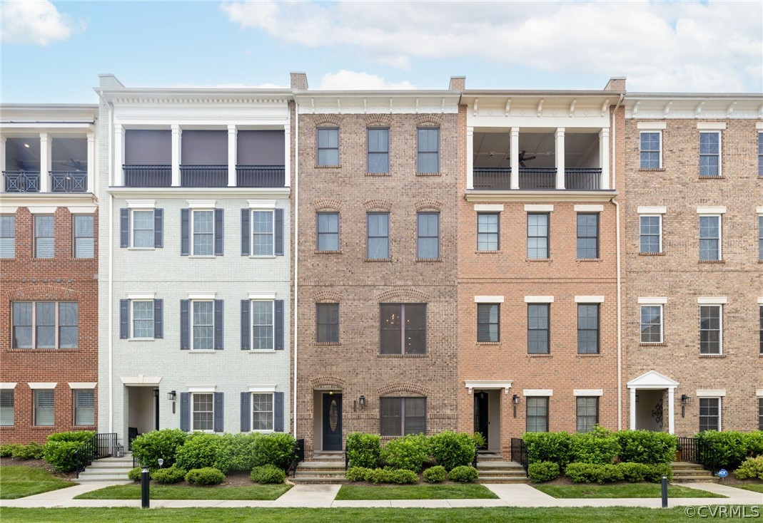 a view of a brick building next to a yard