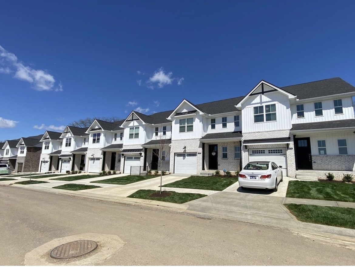 a front view of a residential apartment building with a yard