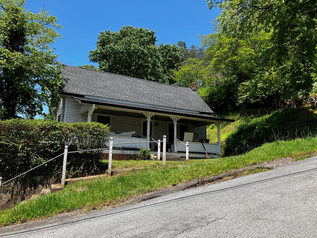 a front view of house with deck and yard