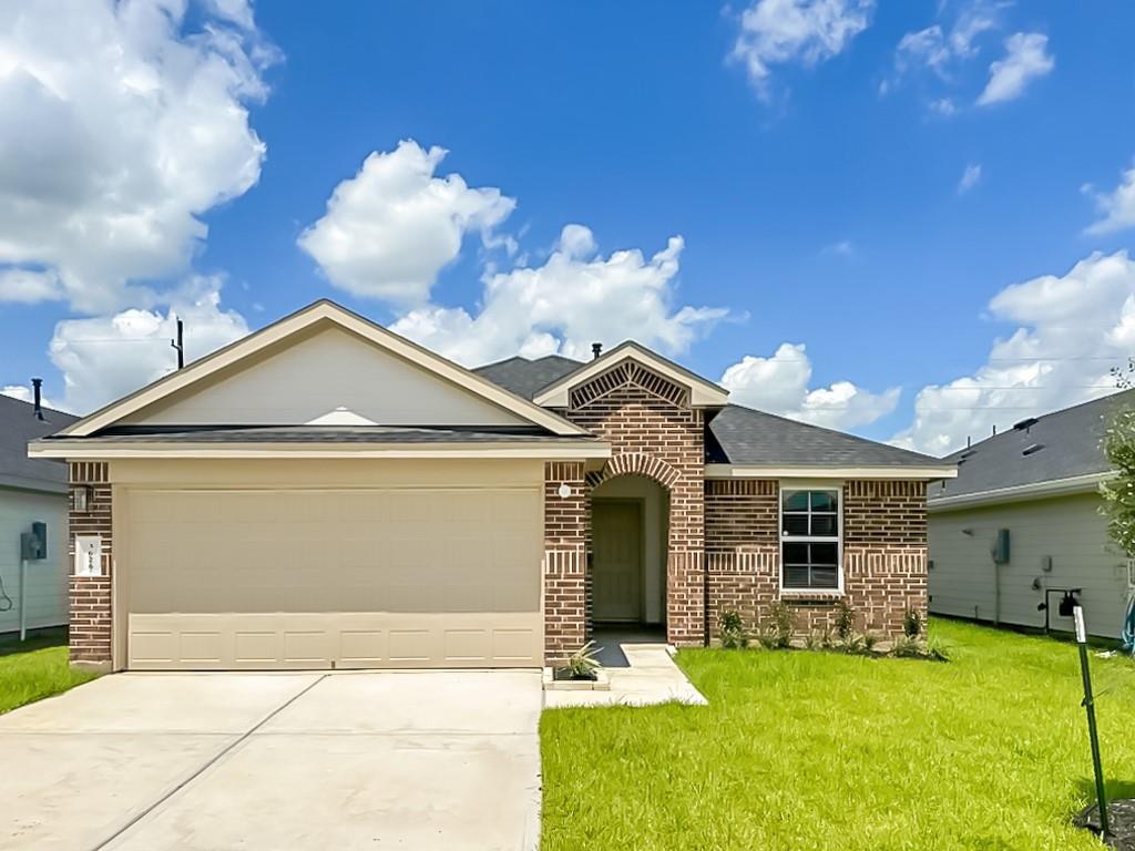 a view of a house with a yard and a garage