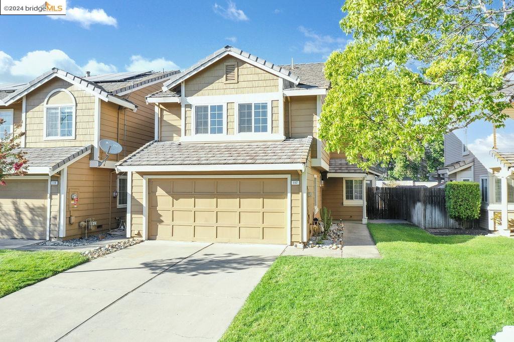 a front view of a house with a yard and garage