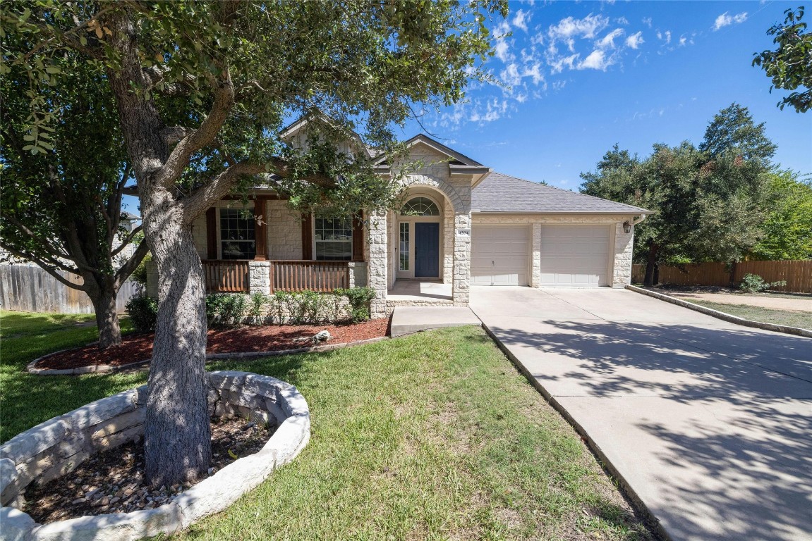 Beautiful upgraded Austin limestone elevation with covered front porch.