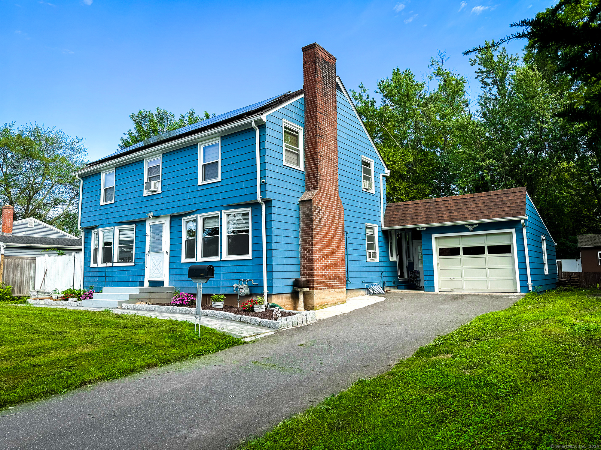 a front view of house with yard and green space