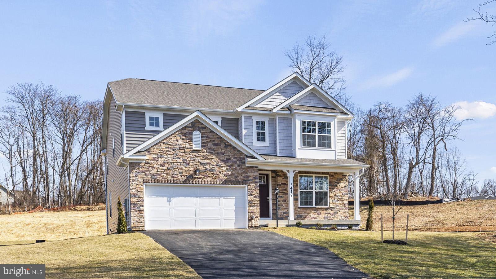 a front view of a house with a yard garage and outdoor seating