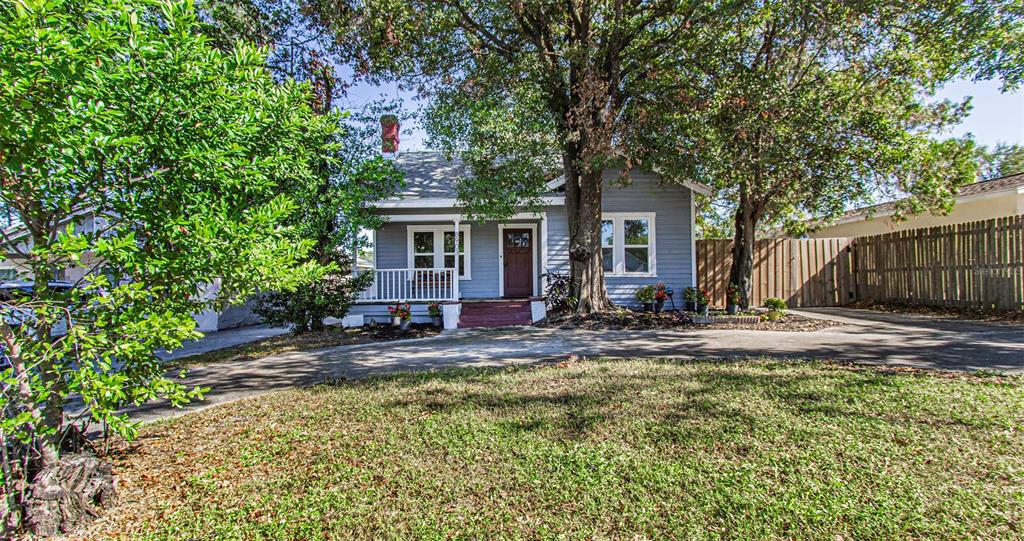 a view of a house with a small yard and plants