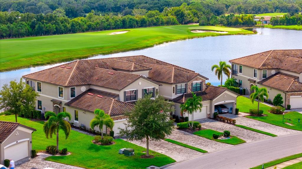 a view of a house with a swimming pool and a yard