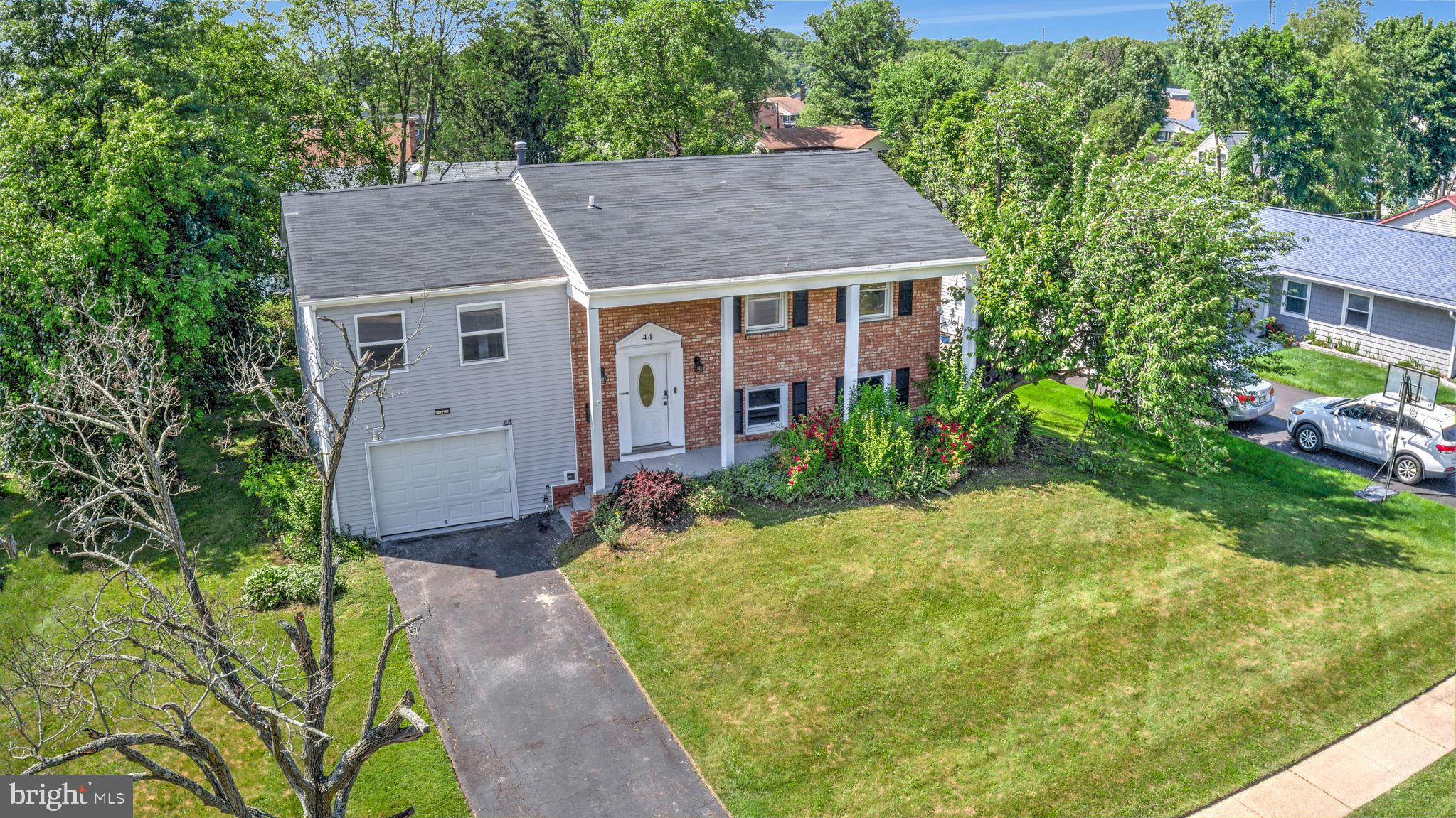 a aerial view of a house with yard and green space