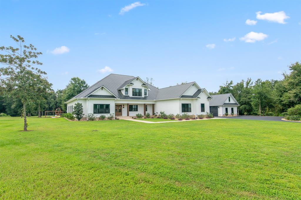 a front view of a house with a garden