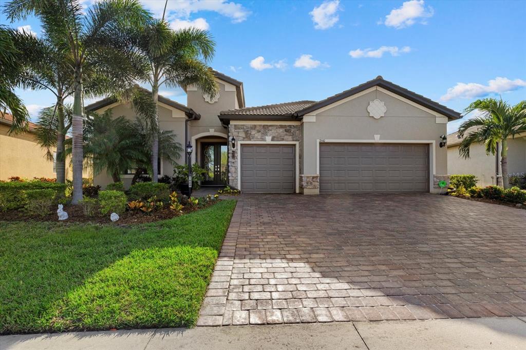 a front view of a house with a yard and garage