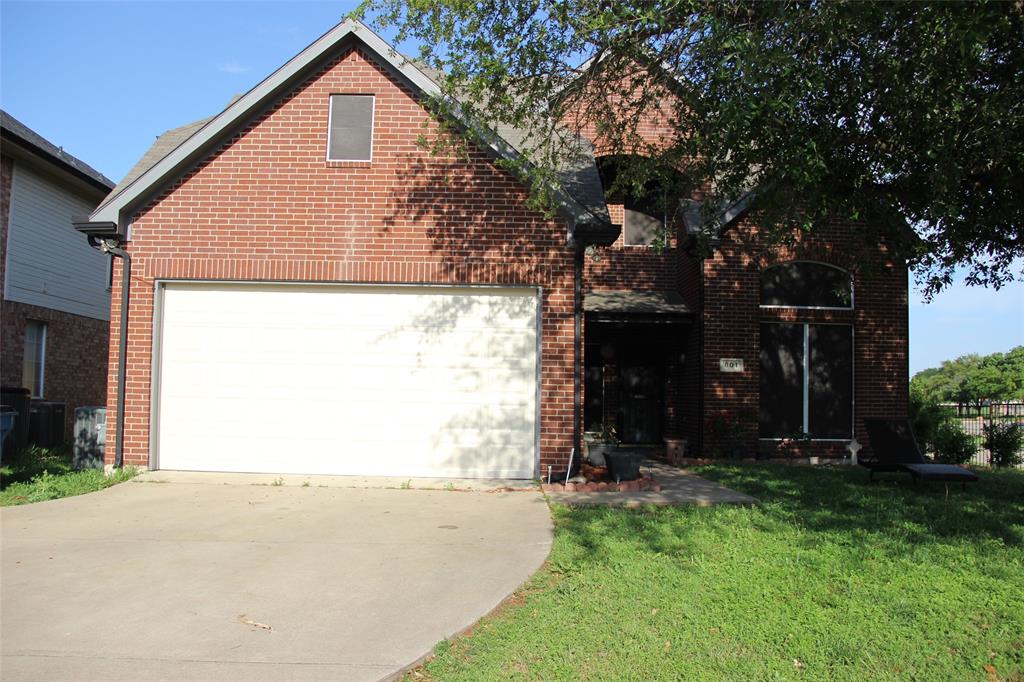 a view of a house with a yard and tree